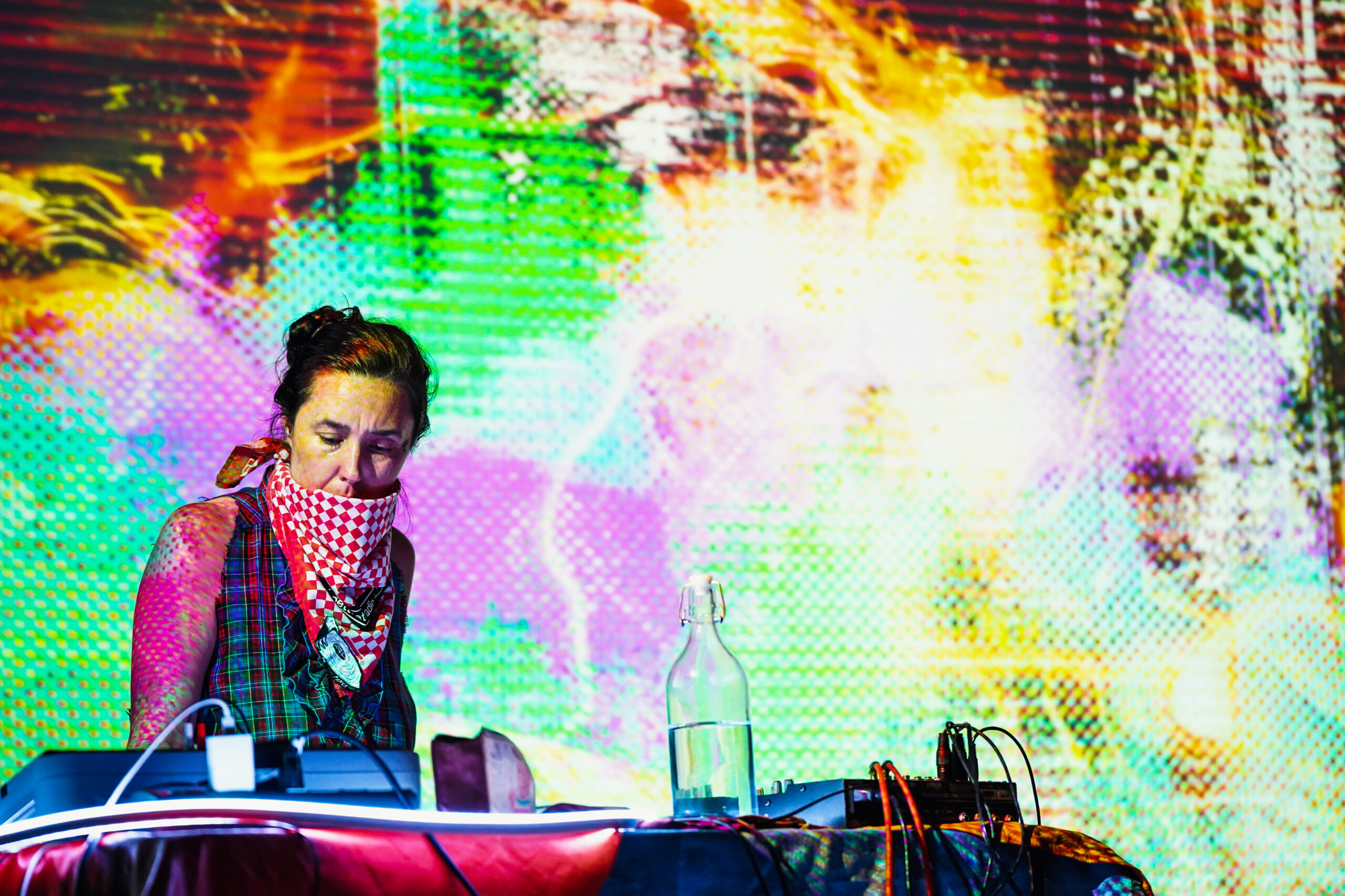 Documentation photograph of live performance with !ZeuqsaV! projected visuals